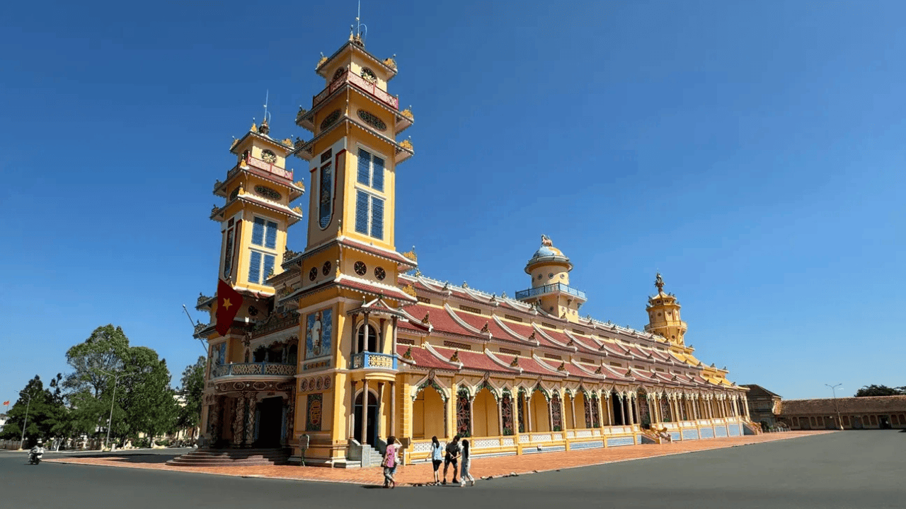 The outside of the Cao Dai Holy See is vibrant, grand, and richly symbolic
